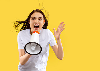 Image showing Portrait of beautiful woman isolated on yellow studio background