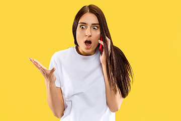 Image showing Portrait of beautiful woman isolated on yellow studio background