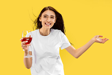 Image showing Portrait of beautiful woman isolated on yellow studio background