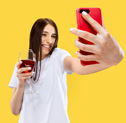 Image showing Portrait of beautiful woman isolated on yellow studio background