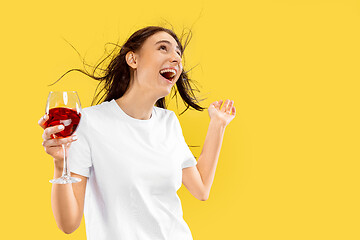 Image showing Portrait of beautiful woman isolated on yellow studio background