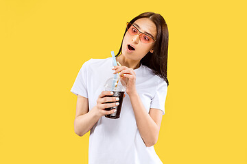 Image showing Portrait of beautiful woman isolated on yellow studio background