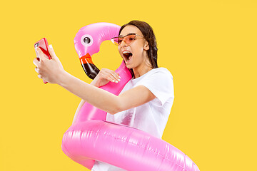 Image showing Portrait of beautiful woman isolated on yellow studio background