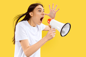 Image showing Portrait of beautiful woman isolated on yellow studio background