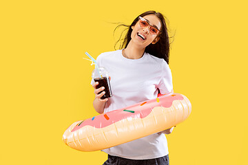 Image showing Portrait of beautiful woman isolated on yellow studio background