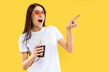 Image showing Portrait of beautiful woman isolated on yellow studio background