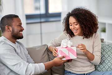 Image showing happy couple with gift at home