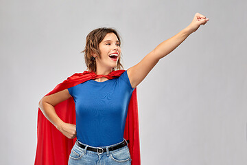 Image showing happy woman in red superhero cape