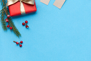 Image showing christmas gift and fir branches with berries