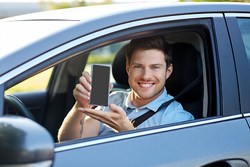 Image showing man or car driver showing smartphone