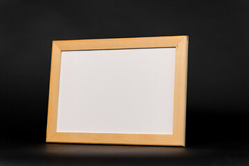Image showing white board in wooden frame on black background