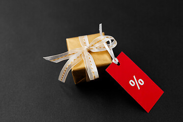 Image showing small gift box and red sale tag with discount sign