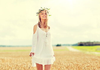 Image showing happy young woman in flower wreath on cereal field