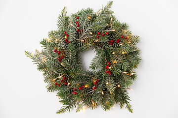 Image showing christmas fir wreath with berries and lights
