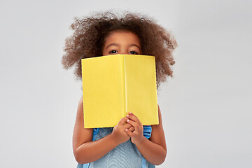 Image showing happy little african girl with book