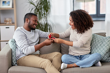 Image showing african american man giving woman engagement ring