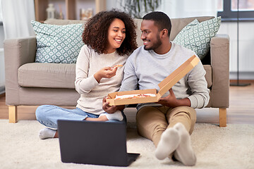 Image showing happy african american couple eating pizza at home