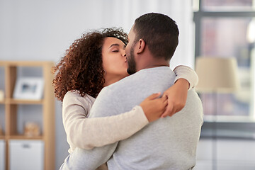 Image showing happy african american couple kissing at home