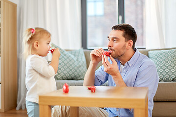 Image showing father and daughter playing tea party at home