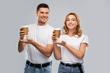 Image showing portrait of happy couple with takeaway coffee cups