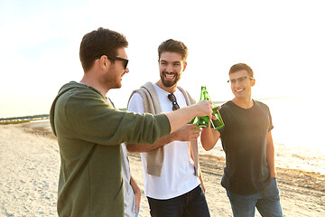 Image showing young men toasting non alcoholic beer on beach