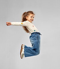 Image showing smiling little girl jumping