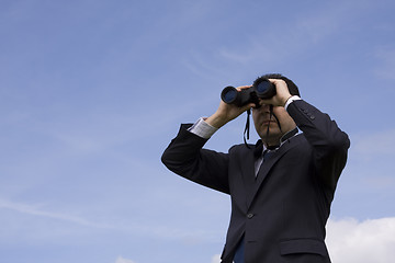 Image showing Businessman looking through binoculars