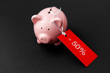 Image showing piggy bank with red sale tag on black