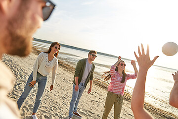 Image showing friends playing volleyball on beach in summer