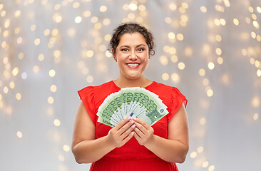 Image showing happy woman holding hundreds of money banknotes