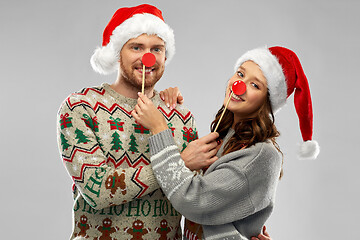 Image showing couple with christmas party props in ugly sweaters