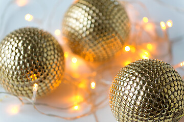 Image showing golden christmas balls and garland lights