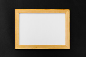 Image showing white board in wooden frame on black background