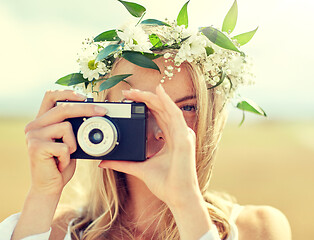 Image showing happy woman with film camera in wreath of flowers