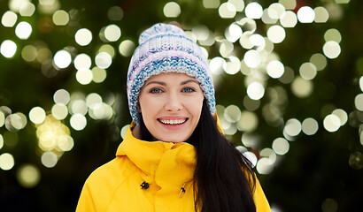 Image showing happy young woman in winter clothes outdoors