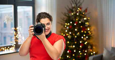 Image showing happy woman photographer with digital camera