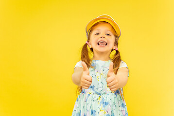 Image showing Beautiful emotional little girl isolated on yellow background