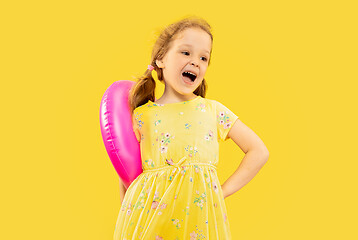 Image showing Beautiful emotional little girl isolated on yellow background