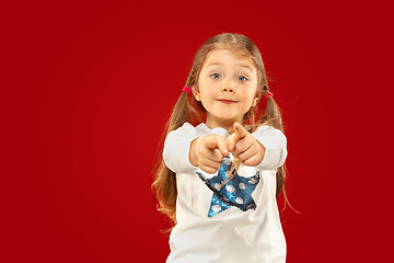 Image showing Beautiful emotional little girl isolated on red background