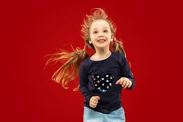 Image showing Beautiful emotional little girl isolated on red background