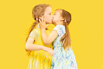 Image showing Beautiful emotional little girls isolated on yellow background