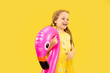 Image showing Beautiful emotional little girl isolated on yellow background