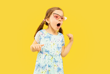 Image showing Beautiful emotional little girl isolated on yellow background