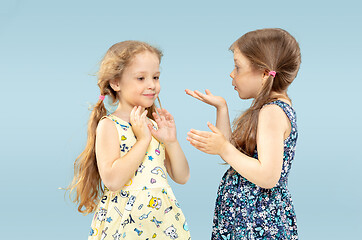 Image showing Beautiful emotional little girls isolated on blue background