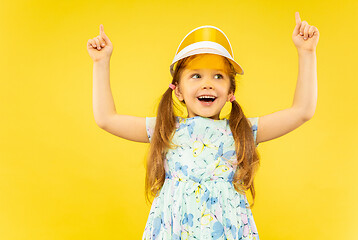 Image showing Beautiful emotional little girl isolated on yellow background