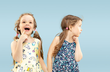 Image showing Beautiful emotional little girls isolated on blue background