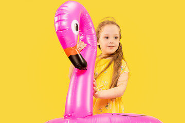 Image showing Beautiful emotional little girl isolated on yellow background