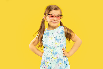 Image showing Beautiful emotional little girl isolated on yellow background