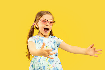 Image showing Beautiful emotional little girl isolated on yellow background