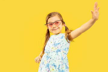 Image showing Beautiful emotional little girl isolated on yellow background